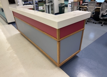 Flexible Solutions for fit client budgets - Nurses stations with Corian countertop caps with refinished oak base edging.