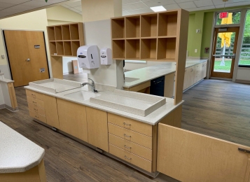 Commercial project a daycare center down in Delaware all custom cabinets, Corian tops, and three mill edging on all doors which adds extra durability. All drawers, full extension drawer slides. Custom cabinetry directly into exterior wall, countertop and cabinets built around notched window area.