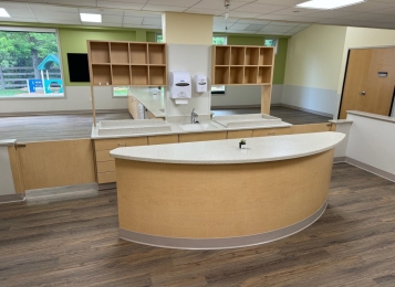 Commercial project a daycare center down in Delaware all custom cabinets, Corian tops, and three mill edging on all doors which adds extra durability. All drawers, full extension drawer slides. Custom cabinetry directly into exterior wall, countertop and cabinets built around notched window area.
