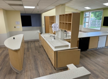 Commercial project a daycare center down in Delaware all custom cabinets, Corian tops, and three mill edging on all doors which adds extra durability. All drawers, full extension drawer slides. Custom cabinetry directly into exterior wall, countertop and cabinets built around notched window area.