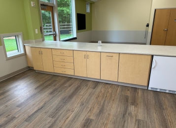 Commercial project a daycare center down in Delaware all custom cabinets, Corian tops, and three mill edging on all doors which adds extra durability. All drawers, full extension drawer slides. Custom cabinetry directly into exterior wall, countertop and cabinets built around notched window area.
