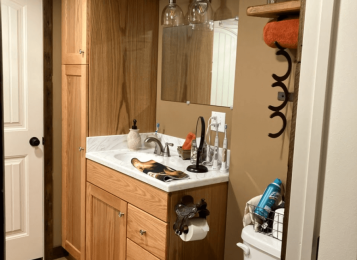 Custom made vanity tall cabinet with pull out drawers. Also custom made Corey on top integrated bowl. Solid oak cabinets. With Plywood construction. Custom stain with clear conversion varnish. Powder room.