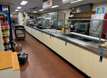 Before and after pictures of a cafeteria job! New cabinet and Corian top at the end of the serving line and a new façade laminated front