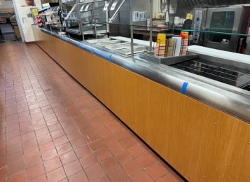 Before and after pictures of a cafeteria job! New cabinet and Corian top at the end of the serving line and a new façade laminated front