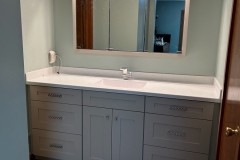 Lincoln, PA - Custom Vanity Cabinets - Shaker style doors, custom paint, clear coat, and conversion varnish. Slow close door guides and doors with a corian top made at our shop. Tri-view mirror.
