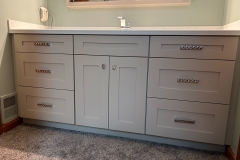 Lincoln, PA - Custom Vanity Cabinets - Shaker style doors, custom paint, clear coat, and conversion varnish. Slow close door guides and doors with a corian top made at our shop. Tri-view mirror.